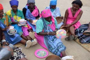 Women working with colourful cloth and beadwork, from the Valoyi archive